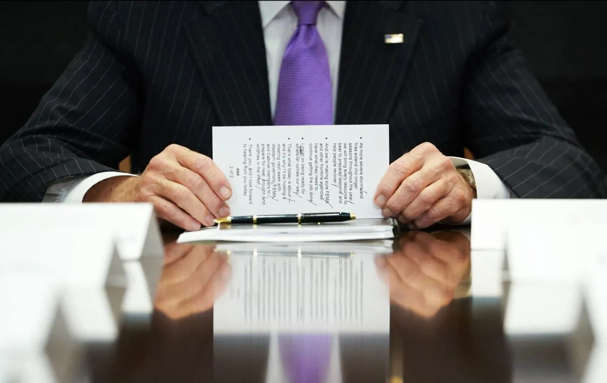 President Joe Biden holds a note card as he takes part in a meeting with Federal Emergency Management Agency (FEMA) officials in the Roosevelt Room of the White House in Washington on June 22, 2021. (Mandel Ngan/AFP via Getty Images)