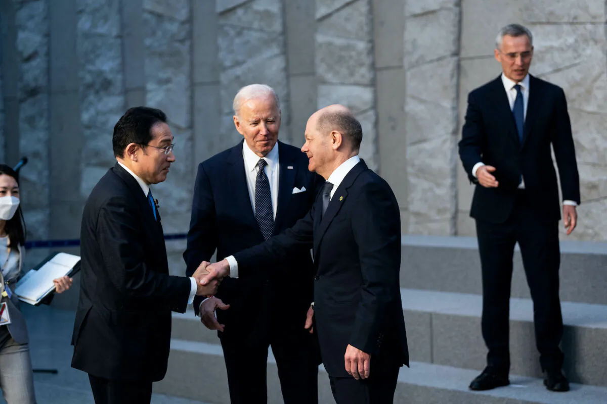U.S. President Joe Biden and NATO Secretary General Jens Stoltenberg (R) look on as Germany's Chancellor Olaf Scholz (2R) shakes hands with Japan's Prime Minister Fumio Kishida (2L) during a photograph with G-7 Leaders at NATO Headquarters in Brussels on March 24, 2022. (Doug Mills/AFP via Getty Images)