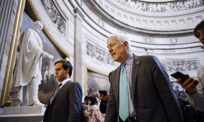 Following a speech on the Senate floor in support of the Bipartisan Safer Communities Act, Senate Minority Whip John Cornyn (R-Texas) talks to reporters as he walks through the U.S. Capitol Rotunda in Washington on June 23, 2022. (Chip Somodevilla/Getty Images)