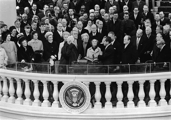 President-elect Richard Nixon (center R) takes the oath of office as he is sworn in as the 37th President of the United States by Supreme Court Chief Justice Earl Warren (center L) during the inauguration ceremony at the US Capitol, Washington, D.C., Jan. 20, 1969. (Pictorial Parade/Getty Images)