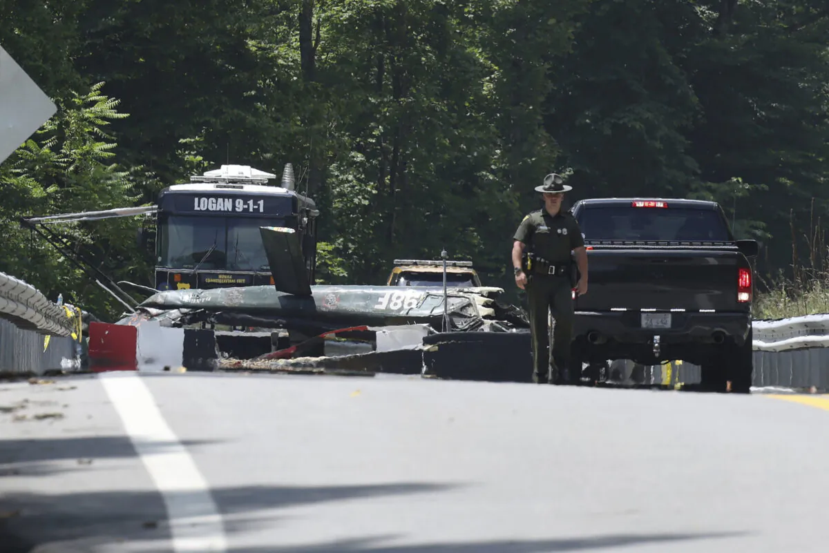 Emergency personnel look over the sight of a  helicopter that crashed in Blair, W.Va., on June 23, 2022. (Chris Jackson/AP Photo)