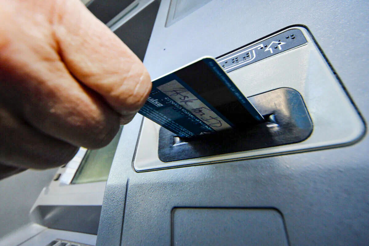 A person inserts a debit card into an ATM in Pittsburgh, PA. on Jan. 5, 2013. (Gene J. Puskar/AP Photo)