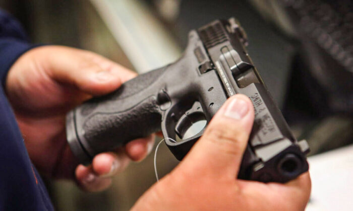 In this file photo, a customer shops for a pistol in a gun shop in Illinois on Dec. 17, 2012. (Scott Olson/Getty Images)