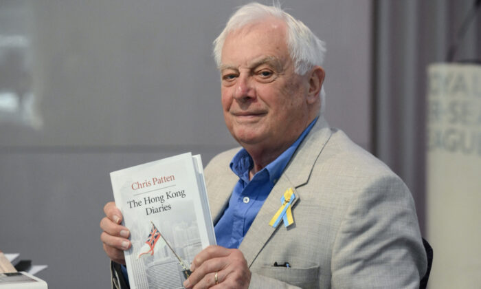 Former Hong Kong governor Lord Chris Pattern, poses with his new book “The Hong Kong Diaries” at the end of a press conference to present it, in central London, on June 20, 2022. July 1, 2022 will mark 25 years since Hong Kong was handed over to China by Britain. (Daniel Leal/AFP)