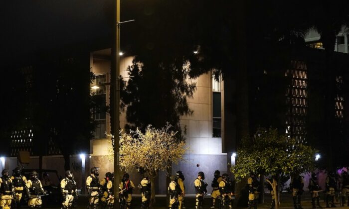 Riot police surround the Arizona Capitol after protesters reached the front of the Arizona Sentate building following the Supreme Court's decision to overturn Roe v. Wade, in Phoenix, on June 24, 2022. (Ross D. Franklin/AP Photo)