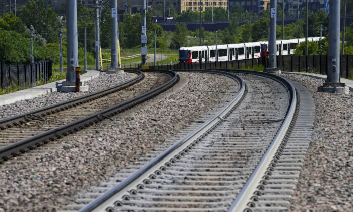 An Ottawa Light Rail Transit (OLRT) train travels along the tracks in Ottawa on June 22, 2022. (The Canadian Press/Sean Kilpatrick)