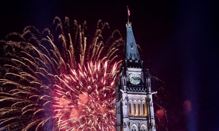 Fireworks explode over the Peace Tower on Parliament Hill at the end of Canada Day celebrations in Ottawa on July 1, 2018. (The Canadian Press/Justin Tang)