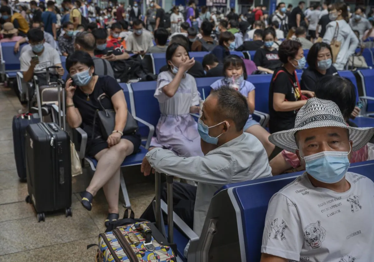 Passengers wait to board trains at Beijing South Railway Station in Beijing, China, on Aug. 27, 2020. (Kevin Frayer/Getty Images)