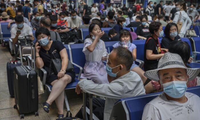 Passengers wait to board trains at Beijing South Railway Station in Beijing, China, on Aug. 27, 2020. (Kevin Frayer/Getty Images)