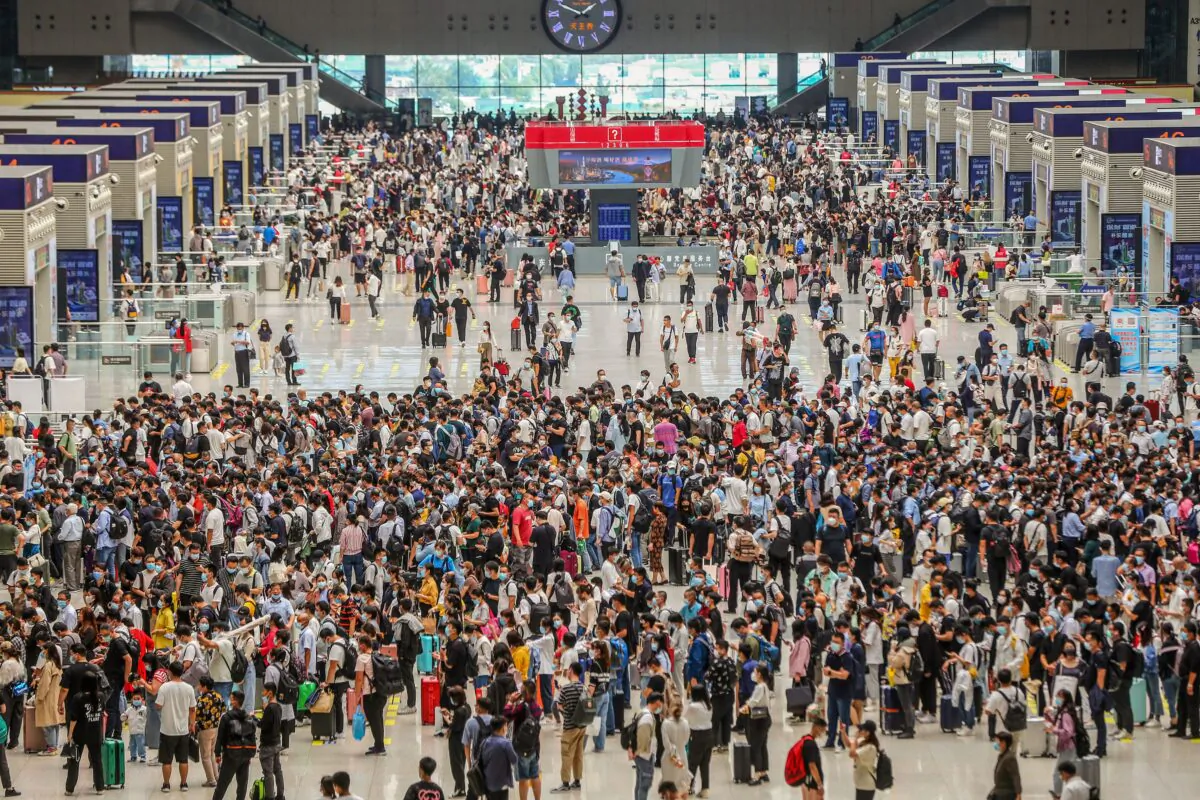 Passengers wait for their train to arrive at the Zhengzhou East railway station in Zhengzhou, Henan Province, China, on Sept. 30, 2021. (STR/AFP via Getty Images)