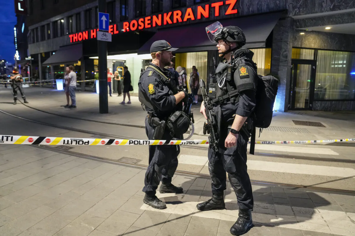 Police stand guard outside a bar in central Oslo, Norway, on June 25, 2022. (Javad Parsa/NTB via AP)