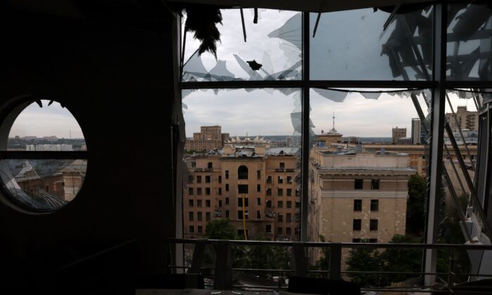 The skyline of the city centre can be seen through a destroyed office building that was hit by shelling, the area hadn’t been hit in weeks, in Kharkiv, Ukraine, on June 25, 2022. (Leah Millis/Reuters)