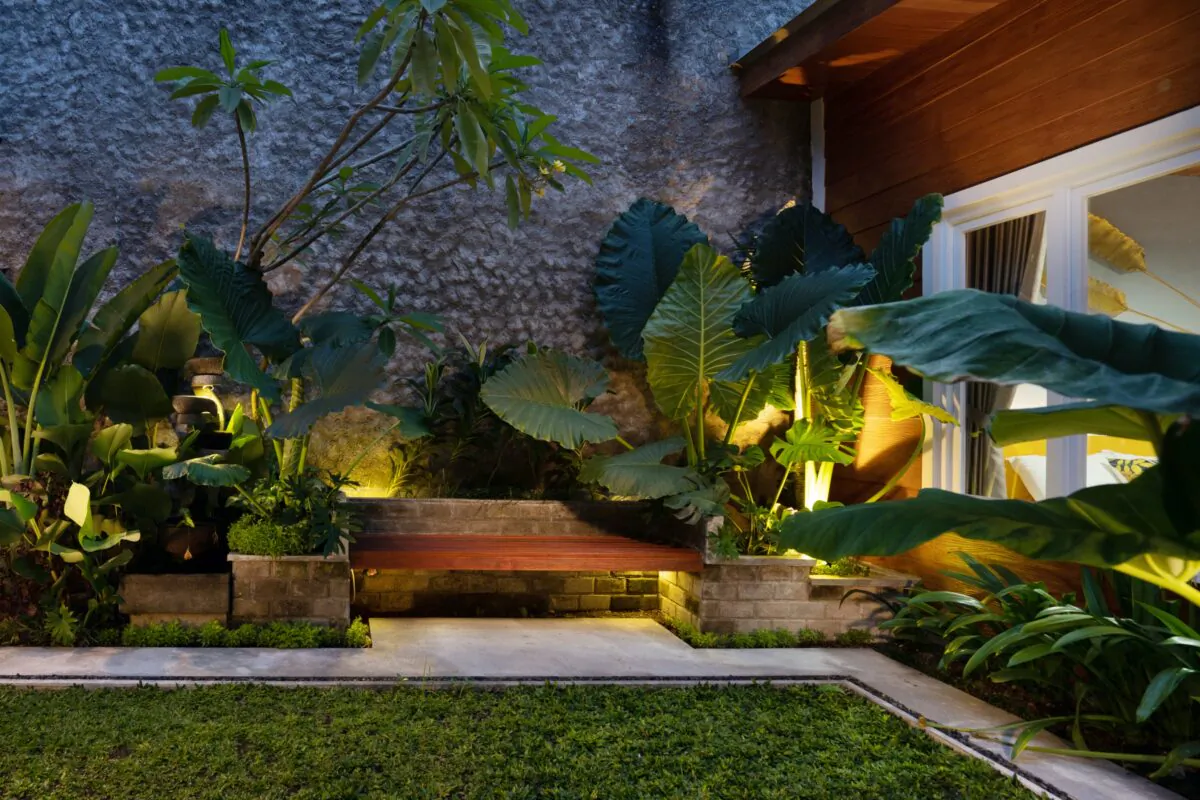 Landscape lighting can be practical and illuminate a dark path between the garage and back door or more fanciful used to highlight a striking flower bed or garden gate entry. (Odua Images/Shutterstock)