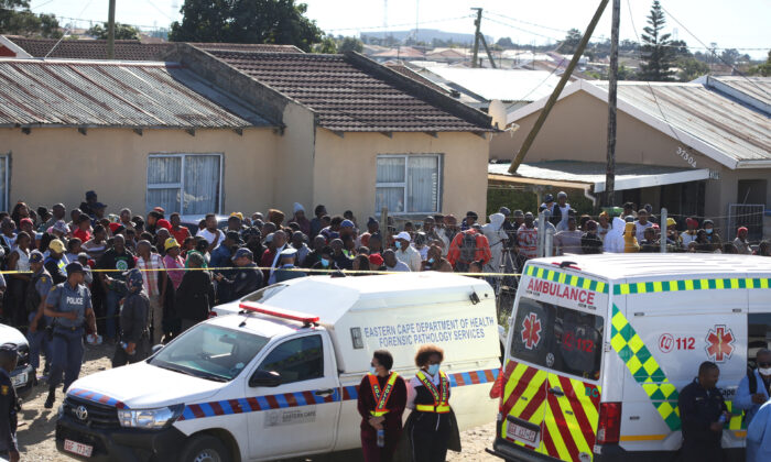 Crowd gathers as forensic personnel investigate after the deaths of patrons found inside the Enyobeni Tavern, in Scenery Park, outside East London in the Eastern Cape province, South Africa, on June 26, 2022. (Stringer/Reuters)