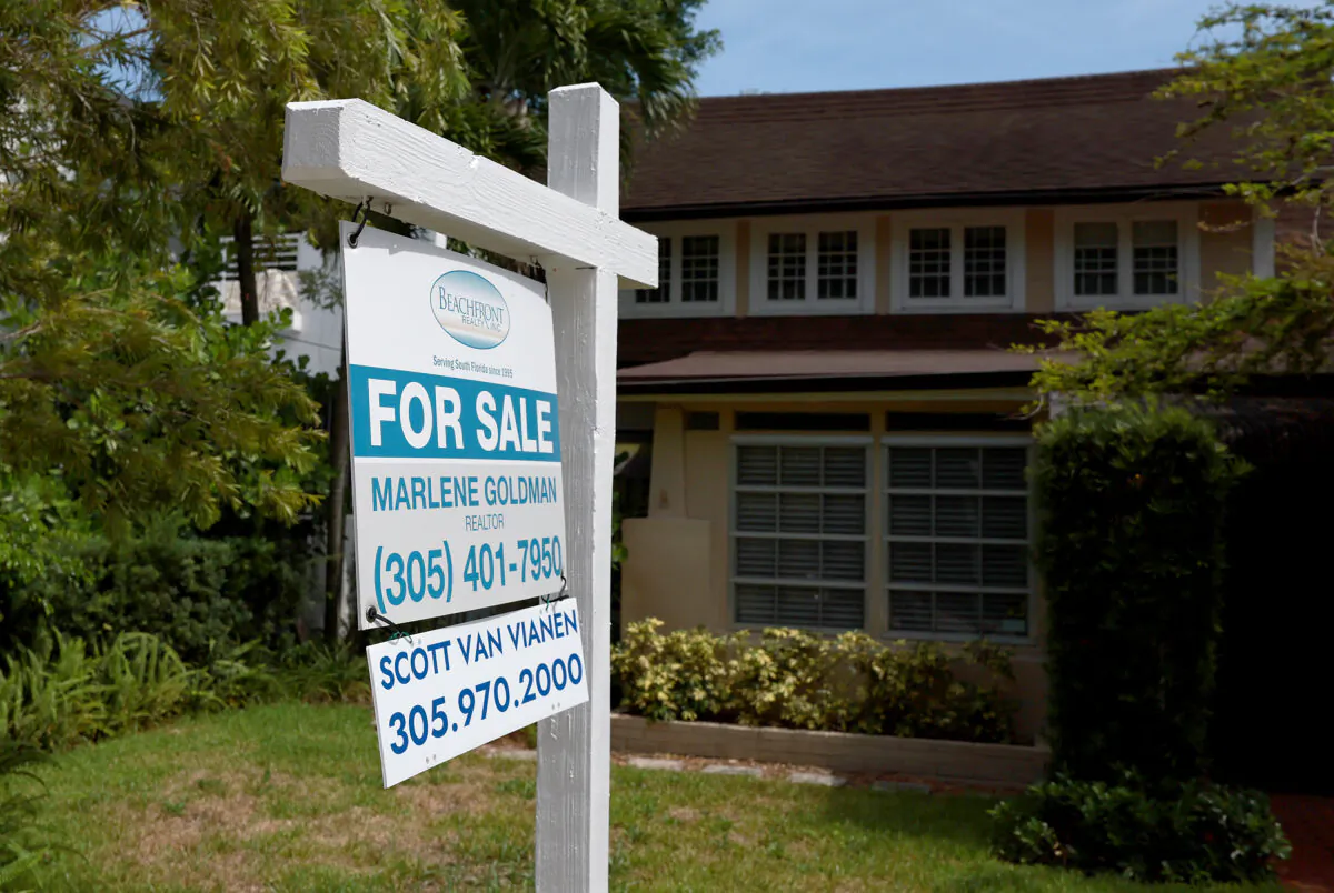 A 'for sale' sign hangs in front of a home in Miami, Fla., on June 21, 2022. (Joe Raedle/Getty Images)