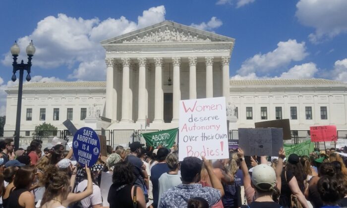 Protesters gather outside Supreme Court in a rally against the June 24 decision that repealed the 1973 Roe v. Wade ruling in Washington on June 25, 2022. (Nathan Worcester/The Epoch Times)