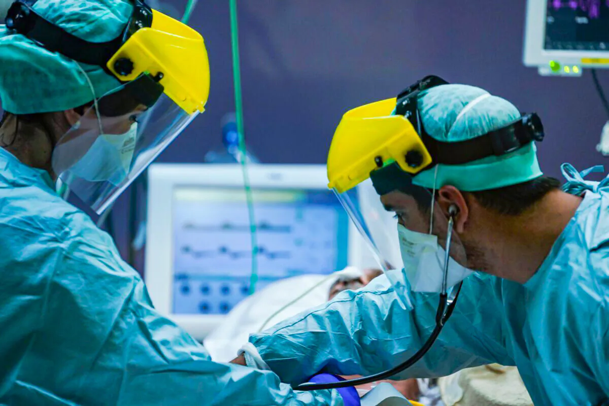 Medical workers wearing protective gears at a hospital in a file photo. (Kenzo Tribouillard/AFP via Getty Images)