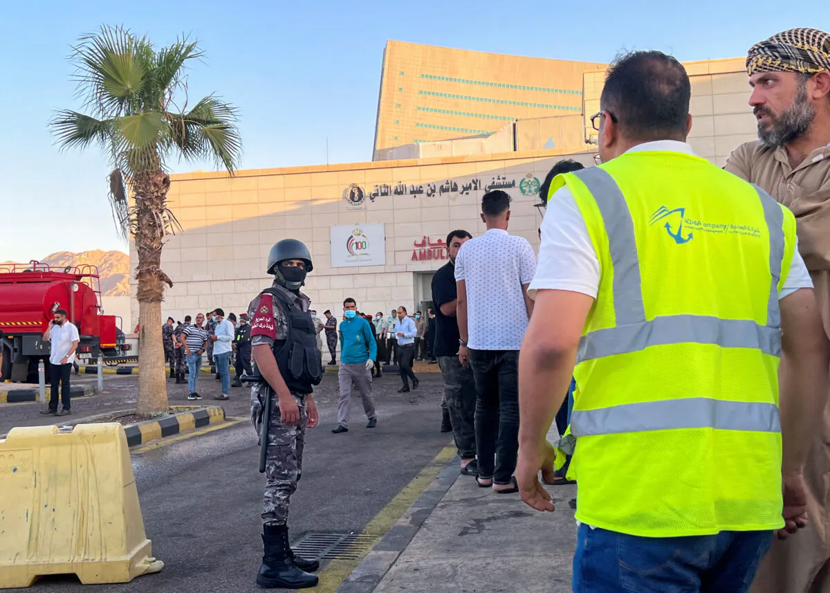 People stand outside a hospital after toxic gas leak from a storage tank in Jordan's Aqaba port on June 27, 2022. (Abraham Farajian/Reuters)