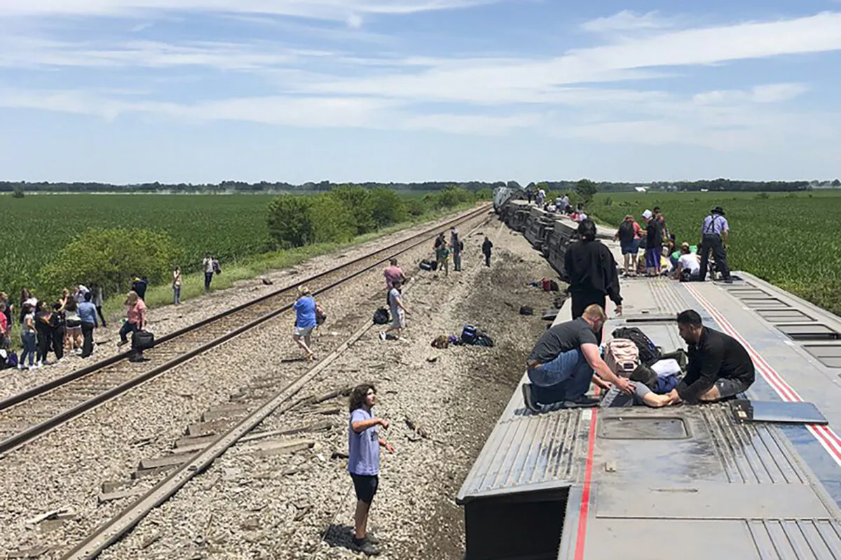 An Amtrak passenger train lies on its side after derailing near Mendon, Mo., on June 27, 2022. (Dax McDonald via AP)
