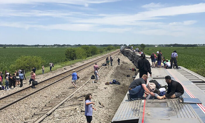 An Amtrak passenger train lies on its side after derailing near Mendon, Mo., on June 27, 2022. (Dax McDonald via AP)