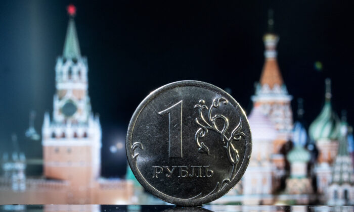 A Russian one rouble coin is pictured in front of a monitor showing St. Basil's Cathedral and a tower of Moscow's Kremlin in this illustration taken on June 24, 2022. (Maxim Shemetov/Illustration/Reuters)