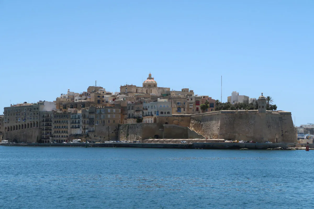 Visitors to Valletta pass the remains of an early opera house and the exterior of Malta's parliament building. 
 (Photo courtesy of Barbara Selwitz)