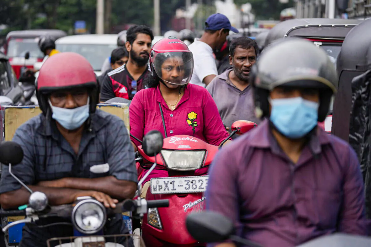 People wait for fuel at a gas station in Colombo, Sri Lanka, on June 11, 2022. (Eranga Jayawardena/AP Photo)