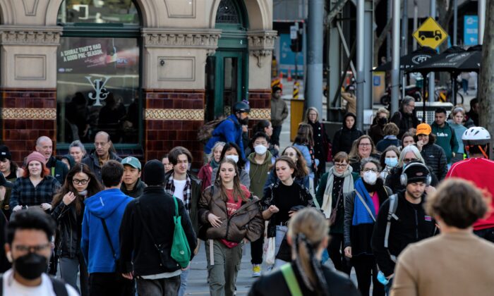People walk along Flinders Street, in Melbourne, Australia, on June 28, 2022. (AAP Image/Diego Fedele)
