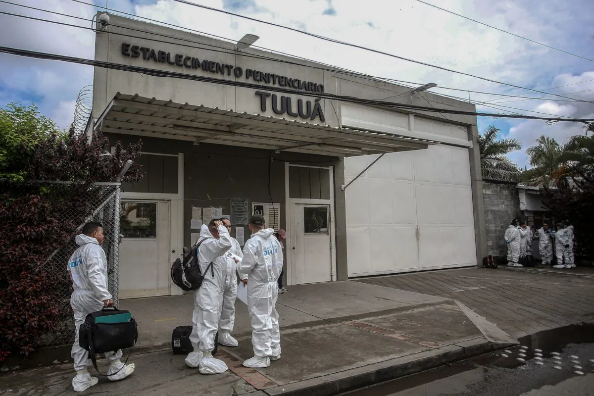 Members of the Technical Investigative Corps (CTI) stand outside the prison after several prisoners died when rioting inmates set a fire early in the morning to try to prevent police entering their enclosure in Tulua, Valle del Cauca Department, Colombia, on June 28, 2022. (STR/AFP via Getty Images)