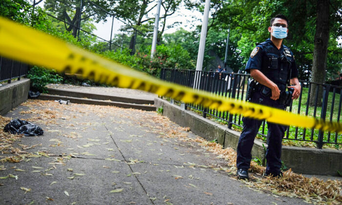 A police officer stands near the scene of an afternoon shooting that left one person dead in the Brooklyn borough of New York City on July 7, 2020. (Spencer Platt/Getty Images)
