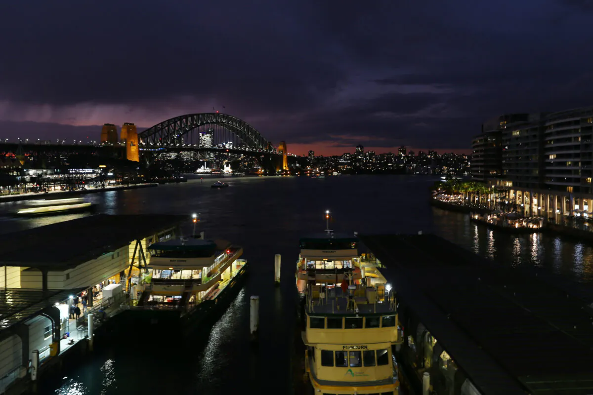 The Sydney Harbour Bridge is seen illuminated in the early evening in Sydney, Australia, on June 21, 2022. (Lisa Maree Williams/Getty Images)