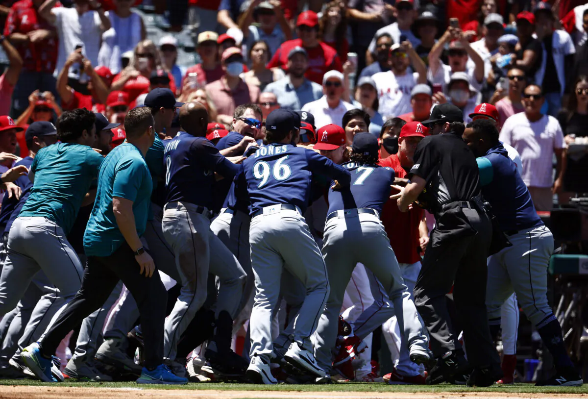 The Seattle Mariners and the Los Angeles Angels clear the benches after Jesse Winker #27 of the Seattle Mariners charged the Angels dugout after being hit by a pitch in the second inning at Angel Stadium in Anaheim, Calif., on June 26, 2022. (Ronald Martinez/Getty Images)