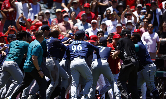 The Seattle Mariners and the Los Angeles Angels clear the benches after Jesse Winker #27 of the Seattle Mariners charged the Angels dugout after being hit by a pitch in the second inning at Angel Stadium in Anaheim, Calif., on June 26, 2022. (Ronald Martinez/Getty Images)