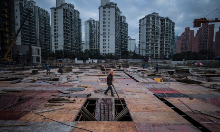 A man works at a construction site of a residential skyscraper in Shanghai on November 29, 2016. (Johannes Eisele/AFP via Getty Images)
