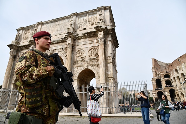 We can look to our ancient past to better understand our present. An Italian soldier patrols near the ancient Colosseum in Rome on March 24, 2017. (Vincenzo Pinto/ AFP via Getty Images)
