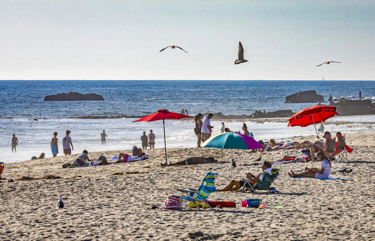 People enjoy the beach in Laguna Beach, Calif., on Dec. 15, 2020. (John Fredricks/The Epoch Times)