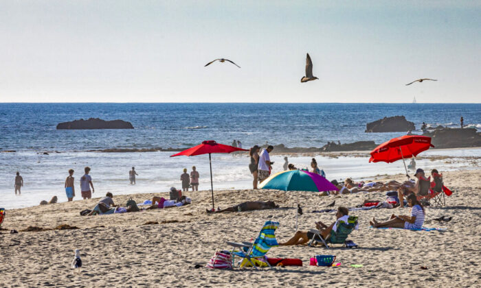 People enjoy the beach in Laguna Beach, Calif., on Dec. 15, 2020. (John Fredricks/The Epoch Times)
