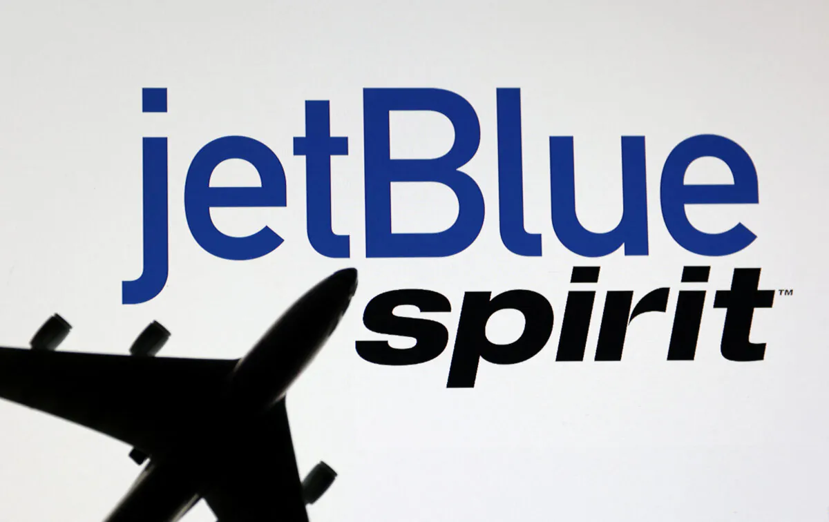 An airplane model is placed on displayed Spirit Airlines and jetBlue Airways logos in an illustration taken on June 21, 2022. (Dado Ruvic/Illustrations/Reuters)
