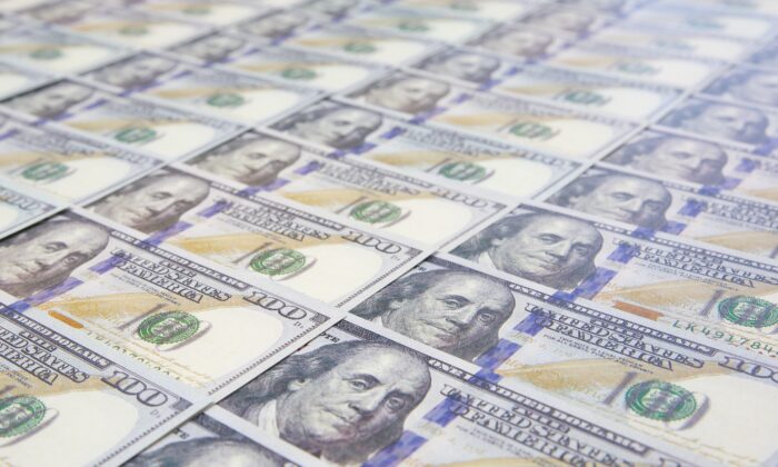Newly printed $100 bills are shown in this file photo. (Only_NewPhoto/Shutterstock)