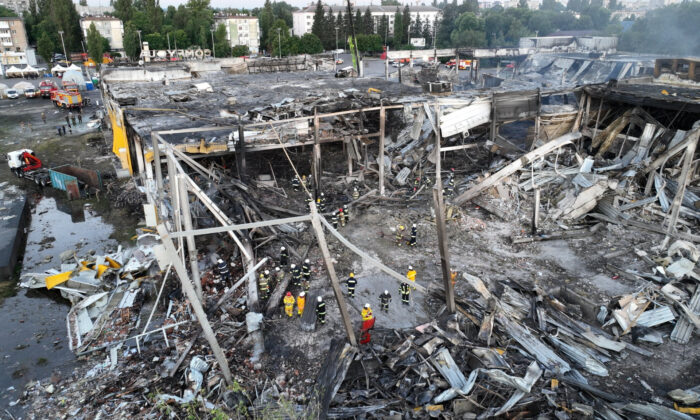 Rescuers work at a site of a shopping mall hit by a Russian missile strike, in Kremenchuk, in Poltava region, Ukraine, in this handout picture released on June 28, 2022. (Press service of the State Emergency Service of Ukraine/Handout via Reuters)