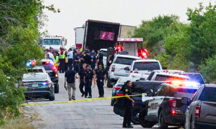 Law enforcement officers work at the scene where people were found dead inside a trailer truck in San Antonio, Texas, on June 27, 2022. (Kaylee Greenlee Beal/Reuters)