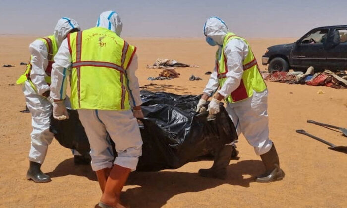 Security personnel recover the body of a migrant in the area between Kufra city and Chadian border with Libya June 28, 2022. (Courtesy of Kufra ambulance service head Ibrahim Belhasan /Handout via Reuters)