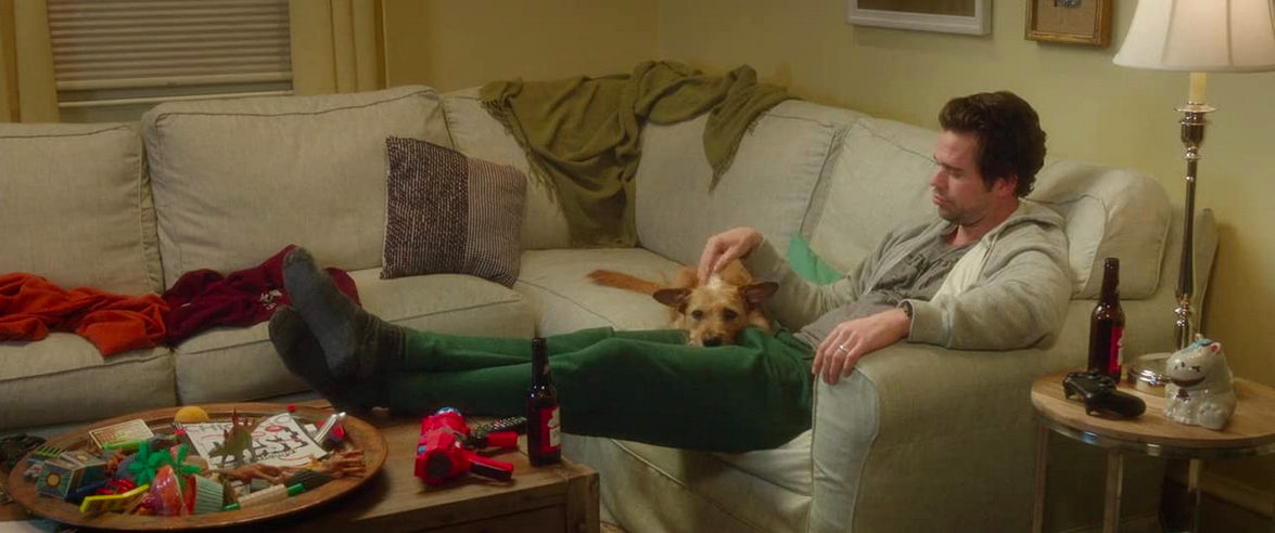  man and dog on couch in BAD MOMS 