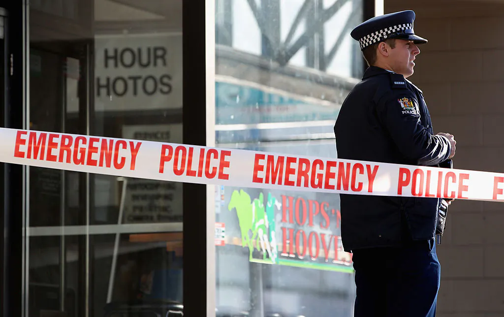 A policeman guards the scene outside a pharmacy in the suburb of Mount Albert in Auckland, New Zealand, on Aug. 24, 2010. (Phil Walter/Getty Images)