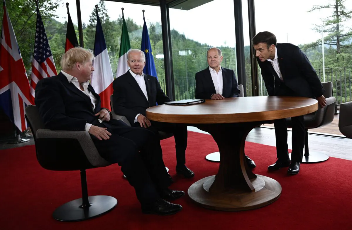 (L-R) UK Prime Minister Boris Johnson, U.S. President Joe Biden, German Chancellor Olaf Scholz, and French President Emmanuel Macron take their seats to attend a meeting of five G-7 leaders at Elmau Castle, southern Germany, on June 28, 2022. (Brendan Smialowski/AFP via Getty Images)