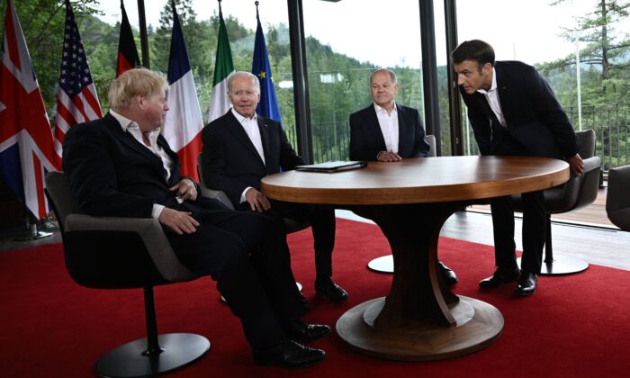 (L-R) UK Prime Minister Boris Johnson, U.S. President Joe Biden, German Chancellor Olaf Scholz, and French President Emmanuel Macron take their seats to attend a meeting of five G-7 leaders at Elmau Castle, southern Germany, on June 28, 2022. (Brendan Smialowski/AFP via Getty Images)