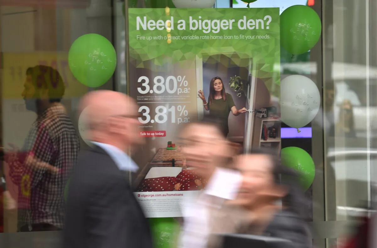 Pedestrians pass a bank advertising interest rates on mortgages in Sydney, Australia, on Oct. 3, 2017. 
(Peter Parks/AFP via Getty Images)