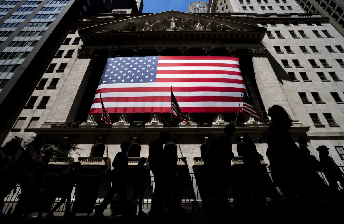 People walk past the New York Stock Exchange in New York on June 29, 2022. (Julia Nikhinson/AP Photo)