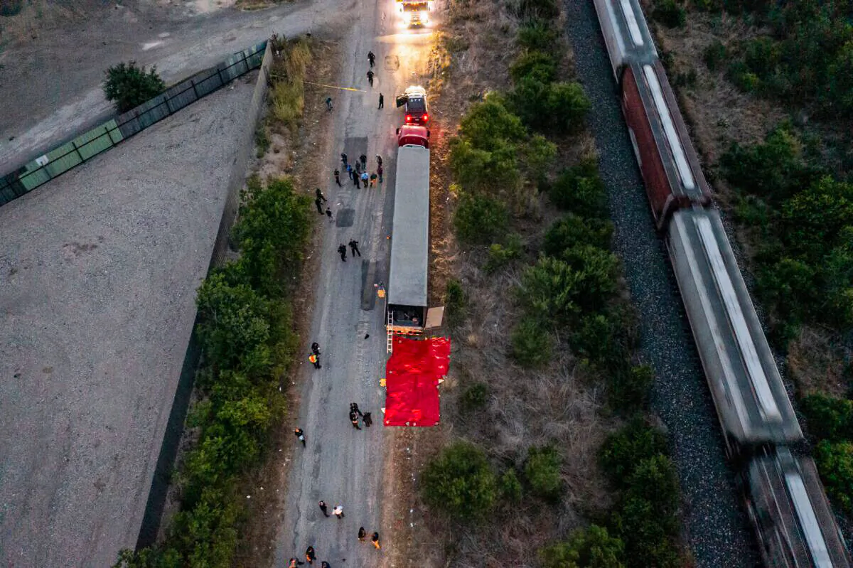 Members of law enforcement investigate a tractor trailer in San Antonio, Texas, on June 27, 2022. (Jordan Vonderhaar/Getty Images)