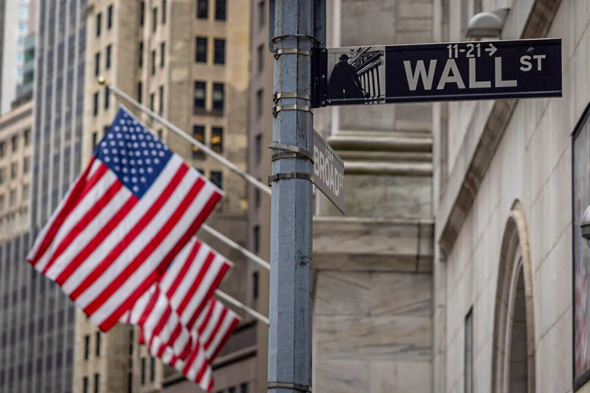 The sign for Wall Street with U.S. flags outside the New York Stock Exchange in New York City on June 16, 2022. (Yuki Iwamura/AFP via Getty Images)